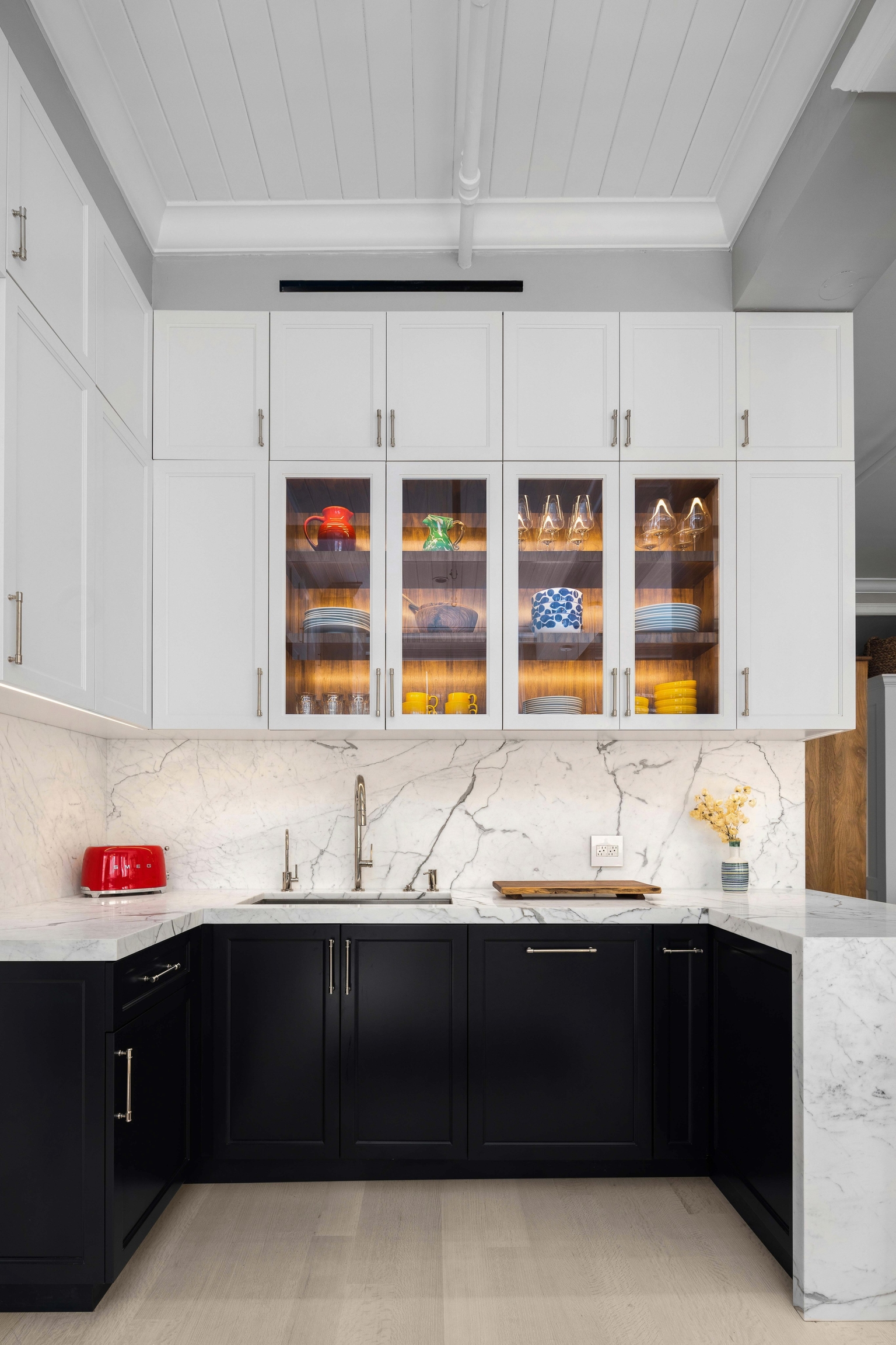 Modern kitchen with black cabinetry and marble counters