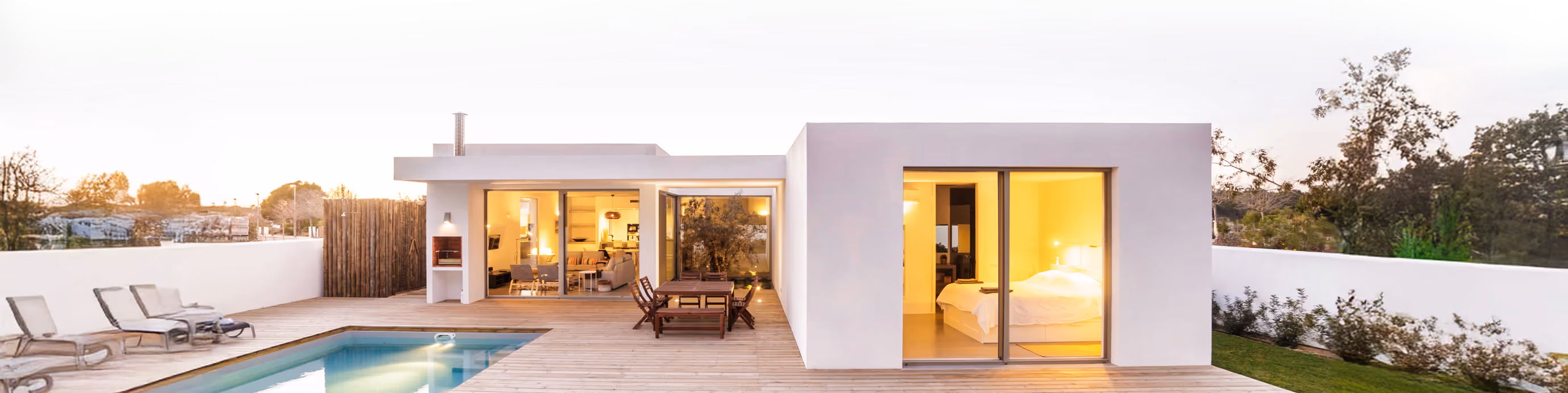 Modern home with a pool at dusk