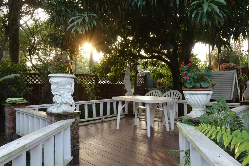 Generate an image of a beautifully renovated outdoor space with a garden, lawn, and patio.